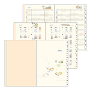 Multiple open planner pages showing calendar and ruled sections.