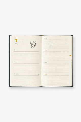 Open weekly diary planner with beige pages and lined sections