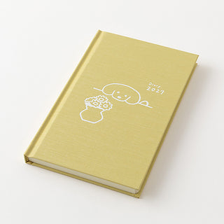 Yellow 2027 planner with fluffy dog and flower line-art on the closed cover