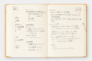 Two-page-a-day planner open to writing pages with handwritten-style text