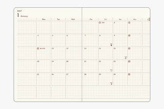Two-page-a-day planner open to monthly calendar grid pages