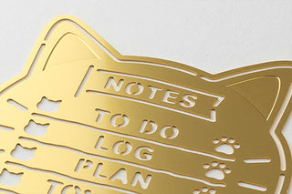 Close-up of gold brass cat notes template with 'NOTES TO DO LOG PLAN' text