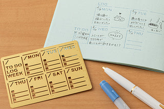 Gold weekly diary template stencil with MON–SUN sections and handwritten notes