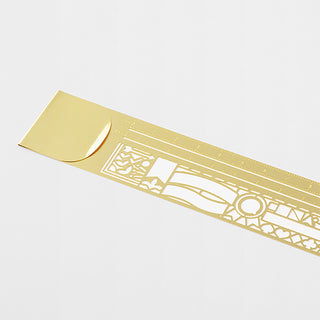 Gold decorative clip ruler with white cutout pattern and measurement markings
