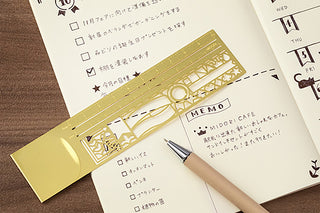 Gold decorative clip ruler with patterned frame design and measurement scale