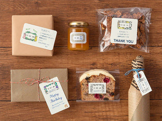 Gift tags and labels with stamped floral date designs on a wooden tabletop