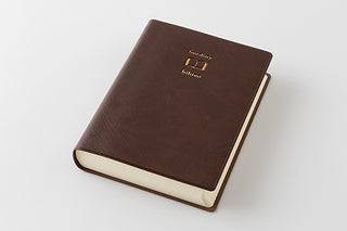 Two-page-a-day free diary with brown cover and “hibino” logo, shown at angle.