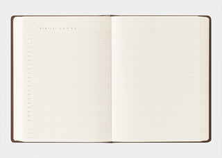 Two-page-a-day free diary opened flat, showing blank cream dotted grid pages.