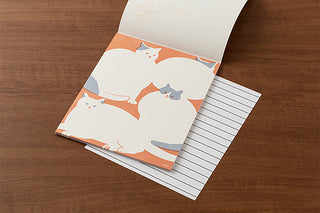 Cat letter pad open to lined sheets with orange-and-white cat cover artwork