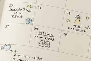 Planner calendar page decorated with Little Monsters stickers and cloud-and-star icons
