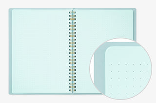 A5 spiral notebook open, light aqua pages with perforated dot pattern detail
