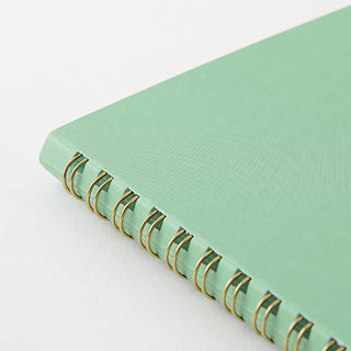 Light aqua spiral notebook spine detail with gold metal coil rings