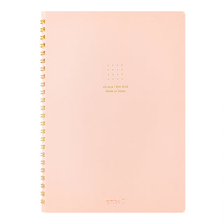 A5 spiral notebook, peach cover with gold coil binding and centered dot logo