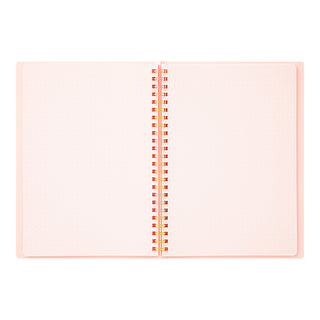 A5 spiral notebook open, peach cover with dotted pages and gold coil spine