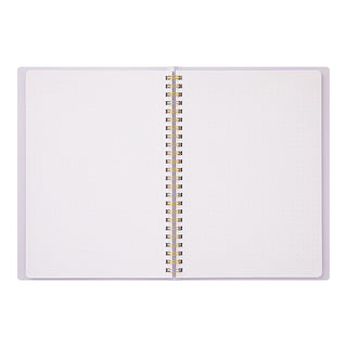 A5 spiral notebook open, lavender purple with dotted pages and gold coil binding