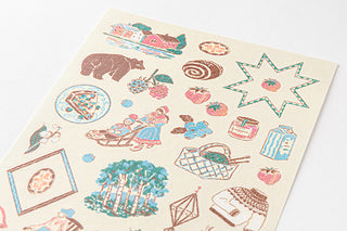 Close-up of illustrated planner sticker sheet with trees, animals, stars, and icons