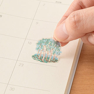Single woodland scene sticker being placed on weekly calendar