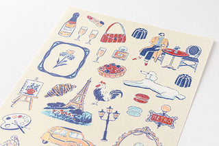 Close-up of France-themed planner stickers: Eiffel Tower, bikes, bottles, and food icons in blue