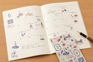 Open planner showing calendar grid with vintage Korea-themed sticker drawings
