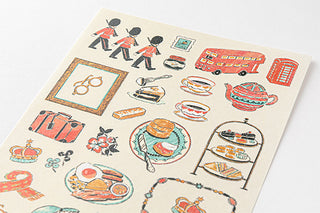 Close-up of travel-themed stickers: bus, food, frame, and illustrated characters
