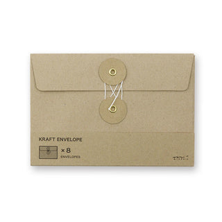 Brown kraft envelope with flap and round button closure; tied string and two round tags.