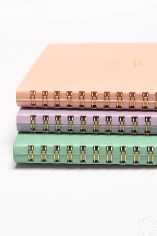 Pastel A5 spiral notebooks set, stacked with peach, purple, and mint covers and gold rings