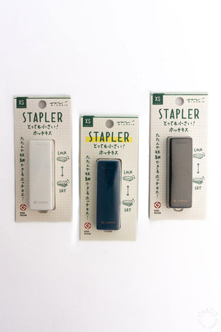 XS compact stapler retail boxes showing black, blue, and white staplers