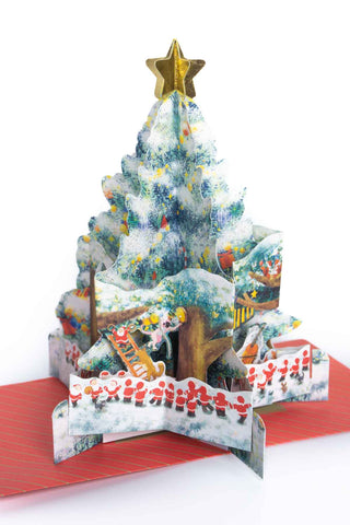 Holiday pop-up card with snowy forest tree, golden star top, and musicians