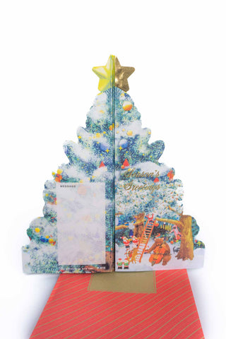 Mini holiday pop-up card showing snowy Christmas tree with star and music band