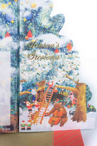 Snowy forest pop-up card reading “Season's Greetings” with Santa musicians