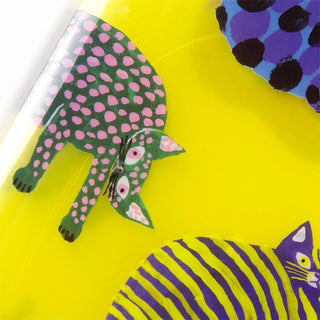 Close-up of bright yellow A5 file folder with purple, pink-spotted cat illustration
