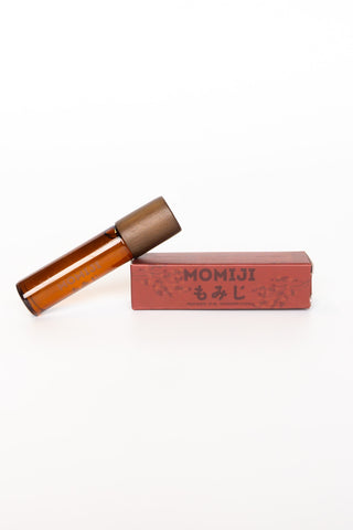Amber glass skin scent bottle with brown cap and red MOMIJI box