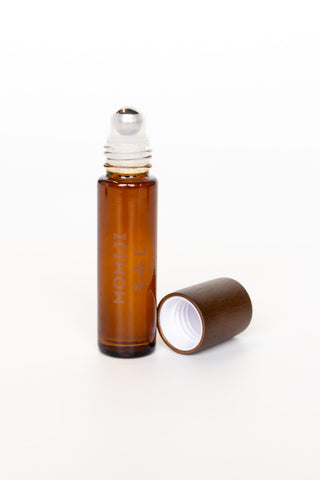 Amber glass roller skin scent bottle with metallic top and brown cap