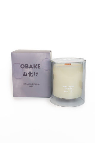 Obake candle in glass jar beside lavender box, cream wax inside