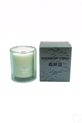 Green glass jar candle with wood wick and SHINRIN-YOKU gift box shown together.