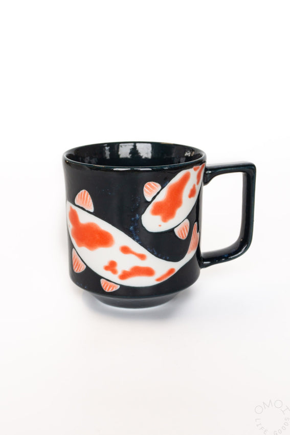 Black ceramic mug with orange and white koi fish pattern, side handle