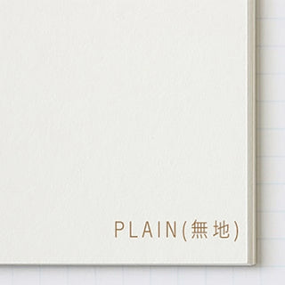 Square notepad edge detail with "PLAIN" text on white cover