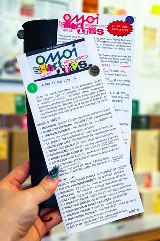OMOI's short trips guidebook, open with itinerary text and map in hand.