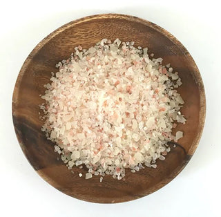 Bath soak crystals in a wooden bowl, fine salt granules