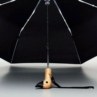 Black compact duck umbrella open interior view, wooden duck handle at base