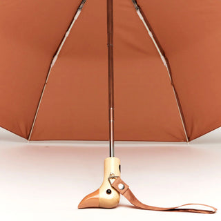 Close-up of mocha-brown umbrella ribs and duckhead handle with strap