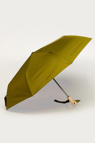 Olive compact umbrella open at angle with duck-head handle and carry strap