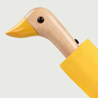 Duck-shaped wooden handle for yellow umbrella with orange beak tip