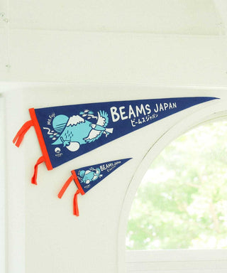 Blue pennant on a white arch with orange tie fringe and BEAMS JAPAN print.