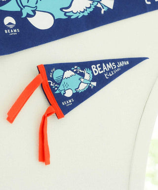 Blue pennant detail showing BEAMS JAPAN text and orange tie fringe.