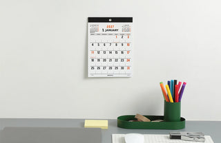 Small 2027 wall board calendar with black header and orange date numbering.