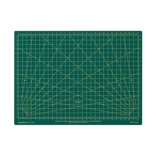 Green A4 cutting mat with printed measurement grid, angles, and ruler markings.
