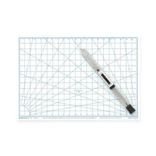 White A5 cutting mat with printed grid and ruler scale
