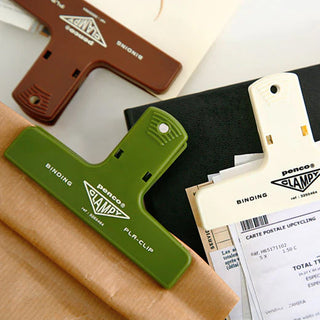 Green and white PENCO Clampy plastic binder clips with binding labels
