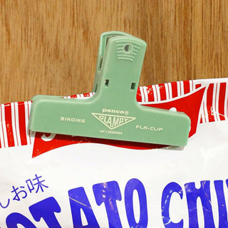 Green plastic Clampy binder clip with binding and PLA-clip text